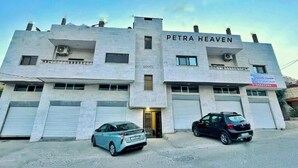 A building named "PETRA HEAVEN" with two cars parked in front. - Petra Heaven Botique (Wadi Musa)