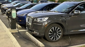 A parking area with multiple cars and a charging station. - Near Universal studios, Scenic Pool Balcony, no resort fee, shuttle option. (Orlando)