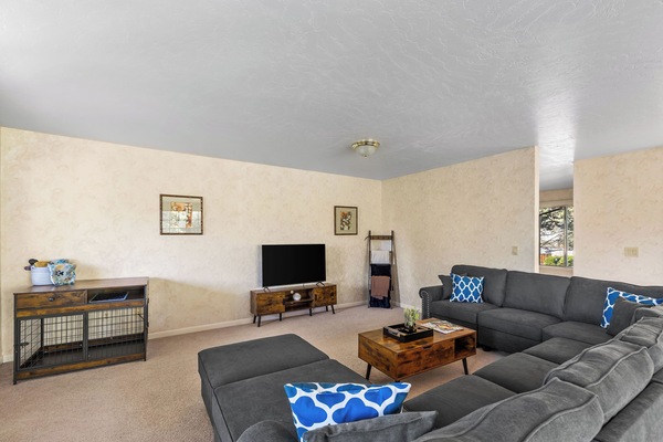 Living room with smart Tv, wifi, and a huge couch