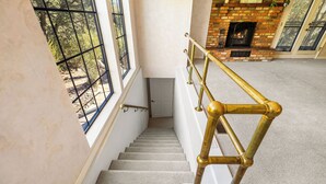 A staircase with a brass handrail leading to a landing. - Prescott Family Getaway: Spacious 4-Bedroom Retreat with Game Room and Wildlife (Prescott)