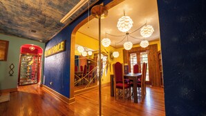 A restaurant interior with wooden floors, red chairs, and a ceiling with a unique design. - Creatives Getaway in Gainesville Florida (Gainesville)