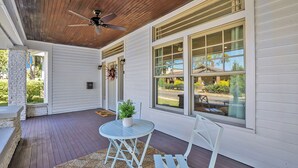 A covered porch with a ceiling fan, white siding, and large windows. - Avondale Charmer-Comfort & Style (Birmingham)