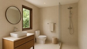 Een moderne badkamer met een groot wastafel, toilet en douche.