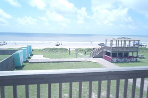 A beach view with a gazebo, a lifeguard tower, and a Bolibar restaurant.