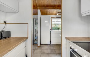 Fridge, stovetop, dishwasher, coffee/tea maker