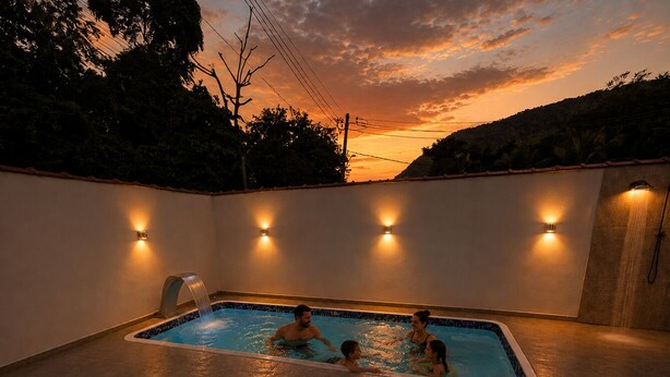 Une piscine intérieure rectangulaire, dotée d’un sol carrelé et entourée de murs dans lesquels sont intégrés des luminaires.