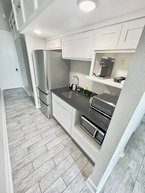 Fridge, microwave, coffee/tea maker, toaster
