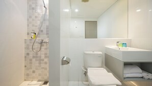 A modern bathroom with a shower, toilet, and sink. - Joylive BSD City (Pagedangan)