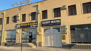 A building with a sign for 'Hotel Moon' and 'Guest House'.