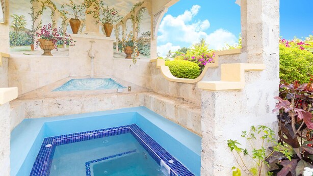 A spa area with a hot tub, potted plants, and a view of the sky. - Villa Casabella | Ocean View - Located in  Fabulous Saint James with Private Pool (Saint James)