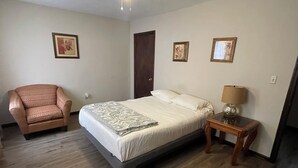A bedroom with a bed, a chair, a nightstand, and a ceiling fan. - Cozy 2-bedroom townhome in awesome Columbia with AC. (Columbia)