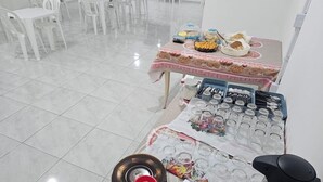 A dining area with a table set for a meal, including plates, cutlery, and glasses.