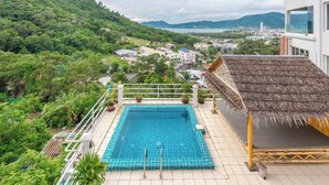 A rooftop pool with a view of a city and mountains. - 4BR PoolVilla and SeaView V199 (Patong)