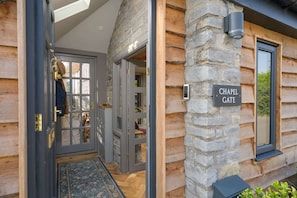 A log cabin with a stone exterior, a glass door entrance, and a sign reading "CHAPEL GATE". - Beautiful Home & Garden in Somerset Countryside (West Lydford)