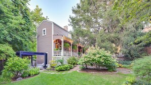 A two-story house with a covered porch and a small garden. - < 1 Mi to Dtwn Salem: Apt w/ Shared Patio & Yard! (Salem)
