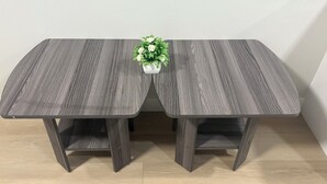 A rectangular table with a dark wood finish and a white vase with green foliage in the center. - Elegant 2-Bed 2-Bath SE Calgary, fully furnished near amenities, mid-term, ready (Calgary)