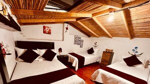 A room with three beds, wooden beams on the ceiling, and a tiled floor. - Balcon Plaza Villa de Leyva Hotel (Villa de Leyva)