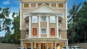 Een hotel met meerdere verdiepingen, een symmetrische gevel, grote ramen en een centrale ingang.