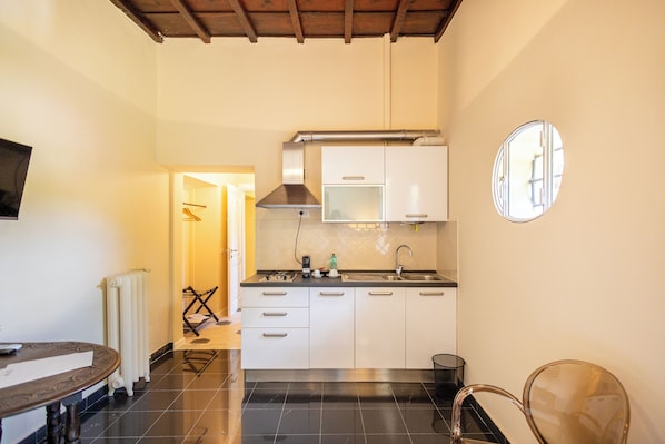 A compact kitchen with white cabinets, a stainless steel sink, and a window above the countertop. - Tenuta dell'inviolata (Velletri)