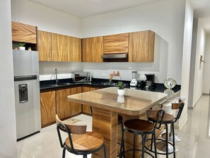 Fridge, microwave, stovetop, coffee/tea maker