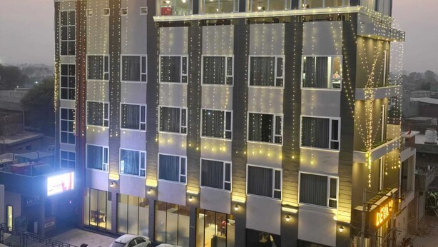 A hotel named Devan with multiple floors, large windows, and a prominent sign. - Hotel Devaan (Sirsa)