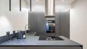 A modern kitchen with a large island, built-in appliances, and a sleek design.