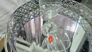 A clear glass table with a decorative metal frame and a glass cover. - Lovely studio with AC in Haifa (Haifa)