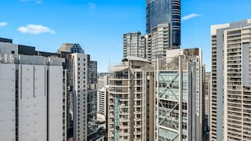 A high-rise urban area with modern buildings, including a prominent cylindrical skyscraper and several residential high-rises.