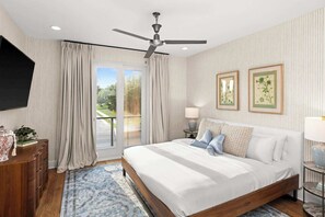 A bedroom with a bed, curtains, a ceiling fan, a TV, a dresser, a lamp, and framed artwork. - Spa Vibes: Peloton, Sauna, Yoga | 8th + 12th Ave South (Nashville)