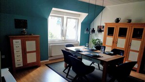 A dining area with a wooden table, chairs, and a cabinet. - Vacation apartment "Beim alten Pfarrhaus" (Zell (Mosel))
