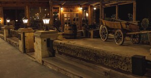 A wooden building with a porch, stone steps, and a wooden cart. - AGES IN CAPPADOCIA PREMIUM SUIT (Nevşehir)
