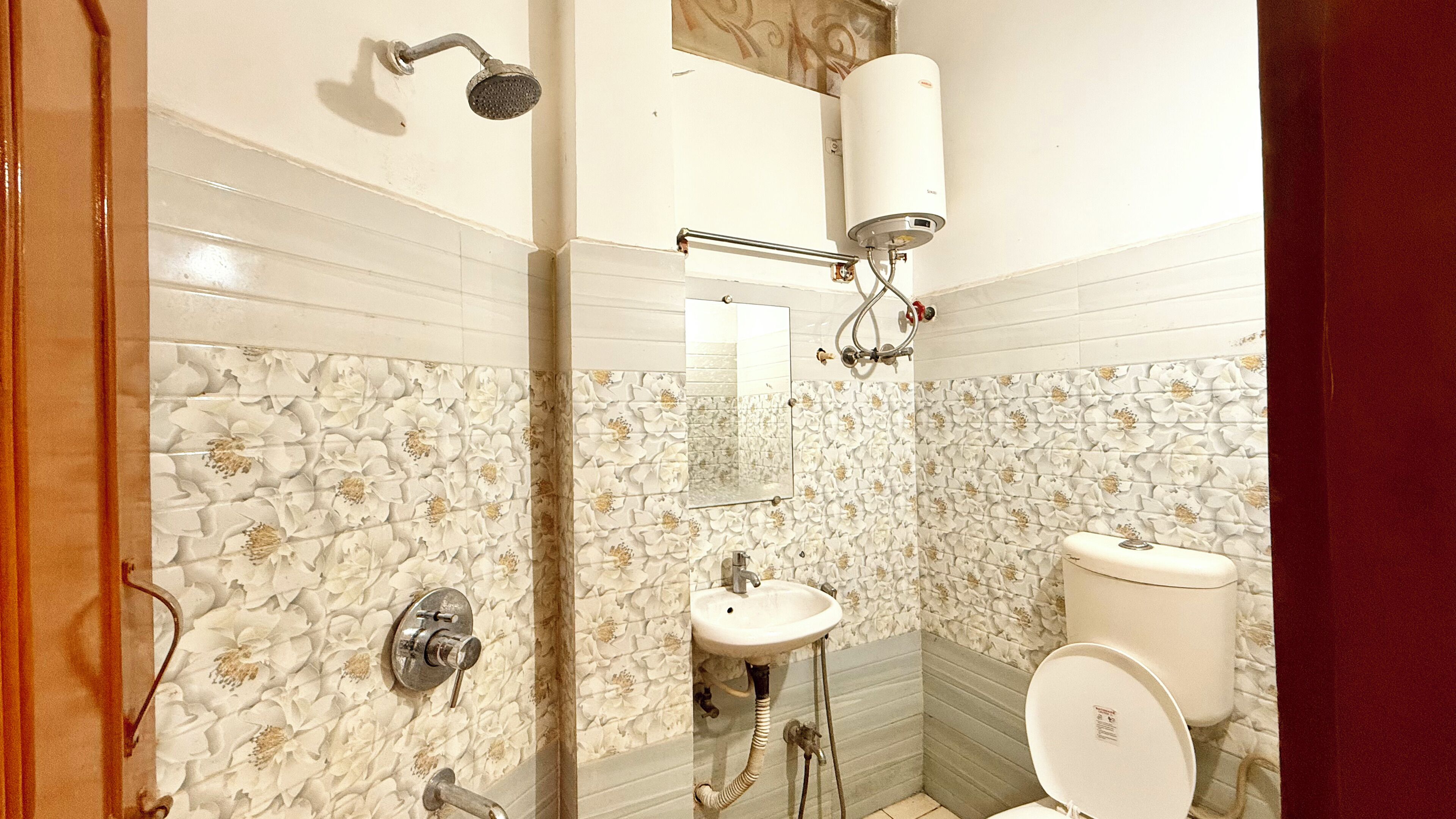 A bathroom with a shower, sink, and toilet.