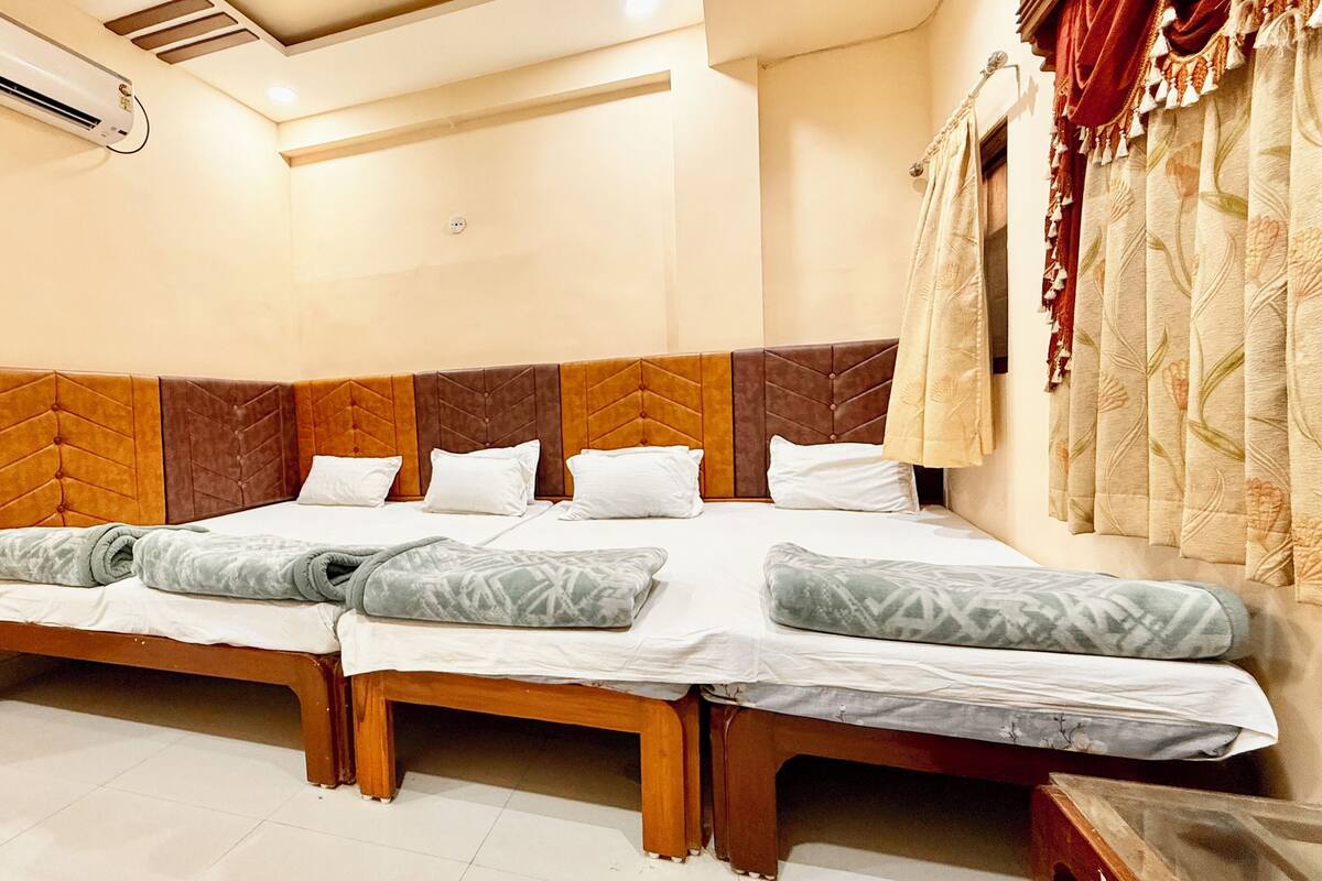 A double bed with a wooden frame and a headboard with a brown and orange design.