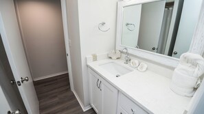 A bathroom with a white sink, a mirror, and a towel rack. - E1102 Directly on the Beach! Dunes of Panama Vacation Rentals (Panama City)
