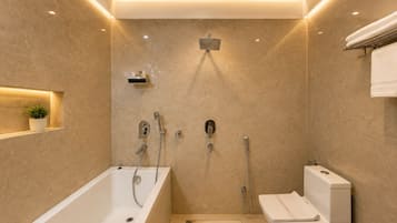 A modern bathroom with a bathtub, shower, and toilet.