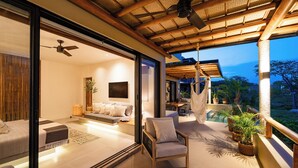 A modern, well-lit interior with a balcony overlooking a garden. - Stylish Escape | Private Plunge Pool | Oceanviews (Huatulco)
