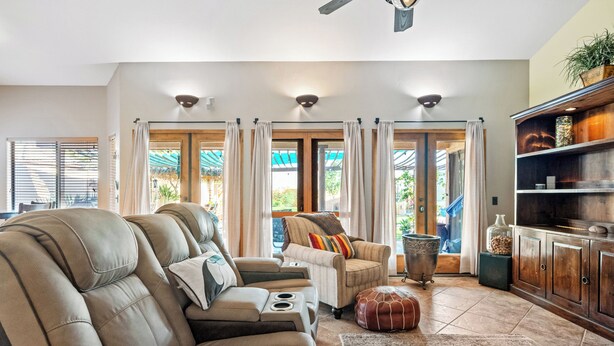 A spacious living room with a sofa set, a coffee table, and a fireplace. - Mesa Desert Oasis • Pool • Grill (Mesa)