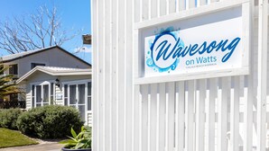 A sign for Wavesong on Watts with a coastal theme, located at Callala Beach, Australia. - Wavesong on Watts - Pet Friendly with Spa (Callala Beach)