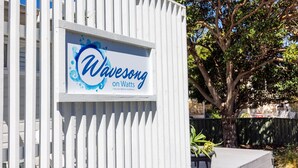 A sign for Wavesong on Watts in Callala Beach, Australia. - Wavesong on Watts - Pet Friendly with Spa (Callala Beach)