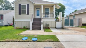 A single-story house with a front porch, a small front yard, and a driveway.