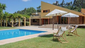 A modern house with a swimming pool, outdoor seating, and a garden. - Liiiving in Caminha Countryside Pool House (Caminha)