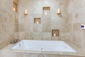 A bathroom with a bathtub, tiled walls, and recessed lighting. - Chickinn Fire Pit Retreat Near Spring River! (Hardy)