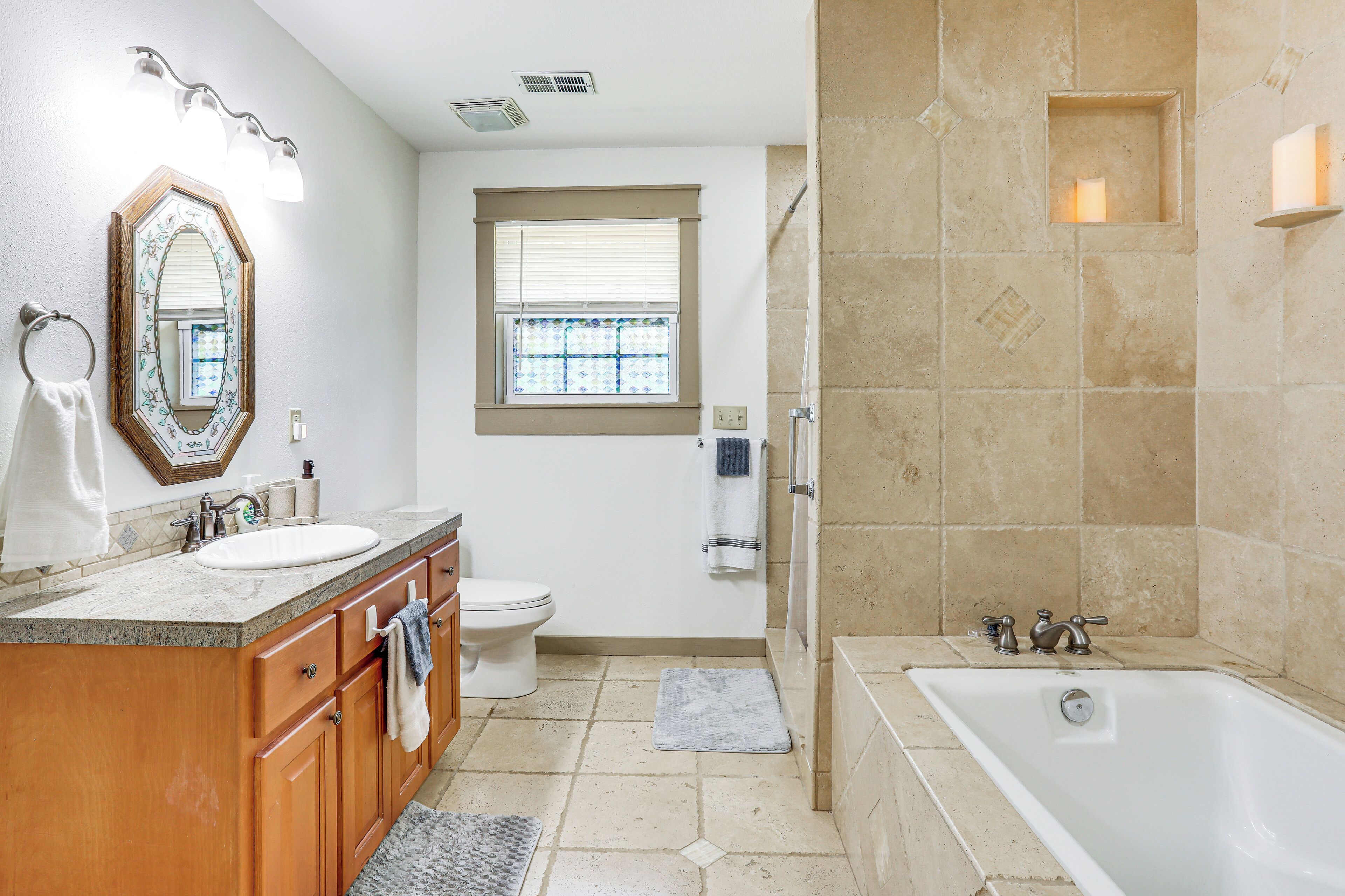A bathroom with a sink, toilet, and bathtub.