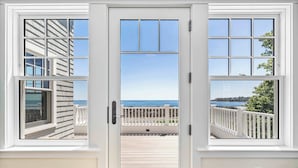 A white door with a view of a balcony and ocean. - Oceanfront Home w/ Semi-Private Beach • Sleeps 12 (York)