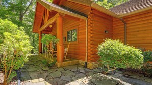 A log cabin with a stone pathway leading to a wooden porch. - Luxe Mountain Escape w/ Hot Tub & Gym Near Boone! (Zionville)