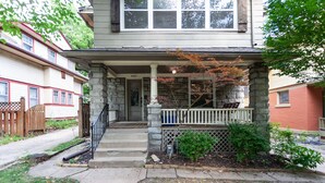 A two-story house with a stone porch and a mailbox. - Beautiful Duplex In Kansas City! 13&14 v2 (Kansas City)