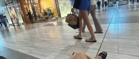 A spacious airport terminal with a Louis Vuitton store.