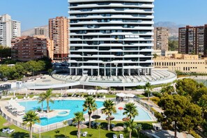A multi-story hotel with a swimming pool and outdoor seating area. - BENIDORM BEACH romantic apartment (Benidorm)