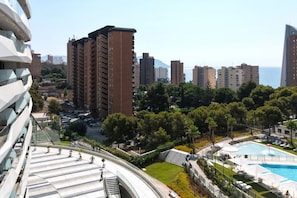 A residential area with high-rise buildings, a swimming pool, and a landscaped park.