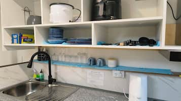 Fridge, microwave, electric kettle, cookware/dishes/utensils